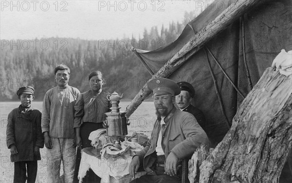 G.I. Ivanov and a Shoria Family at the Table with Samovar Near the Tent, 1913. Creator: GI Ivanov.