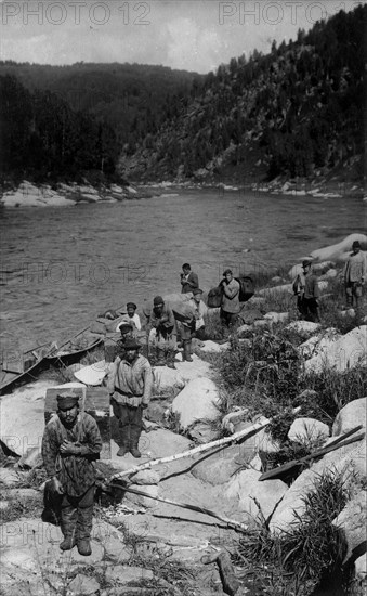 Unloading the Land-Management Expedition Boats, for Detouring the Mrassu River Rapid, 1913. Creator: GI Ivanov.