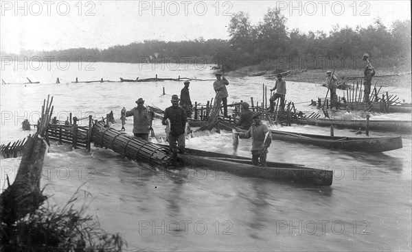 Kamchadals on baht pull out fish from the “muzzles” of the “constipation”..., 1910-29. Creator: Ivan Emelianovich Larin.