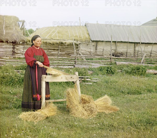 Peasant woman breaking flax;Perm Province, 1910. Creator: Sergey Mikhaylovich Prokudin-Gorsky.