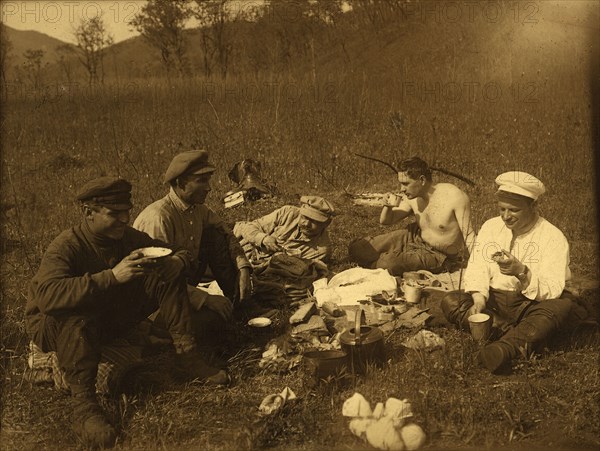 Lunch at the halt. Group portrait, 1920-1929. Creator: Unknown.