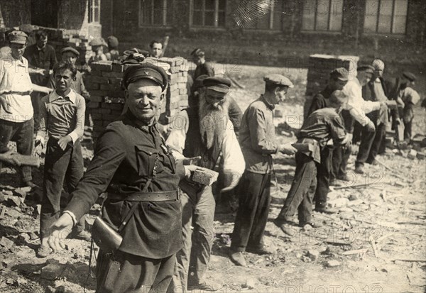 Conveyor system for transferring bricks: Cleanup day at Traktorostroye, Kharkiv, 1920-1929. Creator: Unknown.