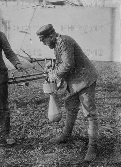 Attaching bomb to German Aeroplane, 16 Jan 1915. Creator: Bain News Service.