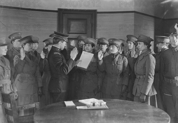 Colonel J.H. Wells swearing in woman motorist, 29 May 1917. Creator: Bain News Service.