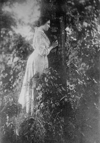 Helen Keller, standing next to tree, 1912. Creator: Bain News Service.