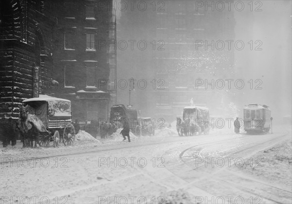 Horse-drawn wagons on snowy street, NY snow storm, 1910. Creator: Bain News Service.