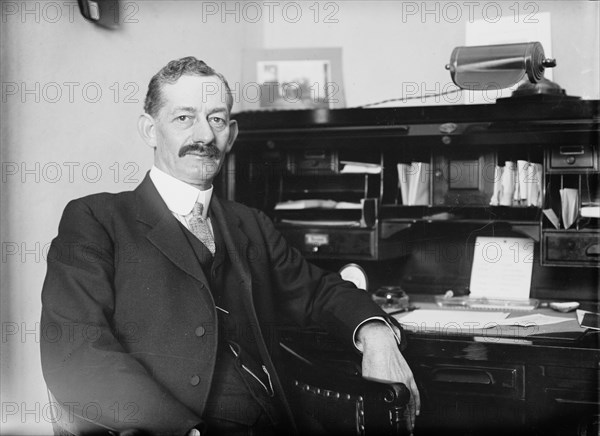 Robt. N. Page seated at desk, 1916. Creator: Bain News Service.