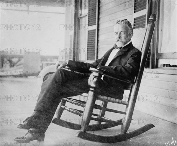 Sen. H.C. Lodge in rocker on porch, 1910. Creator: Bain News Service.