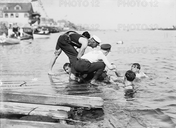 Untying Otto after 45 yd. swim - hands and feet tied, (1910?). Creator: Bain News Service.