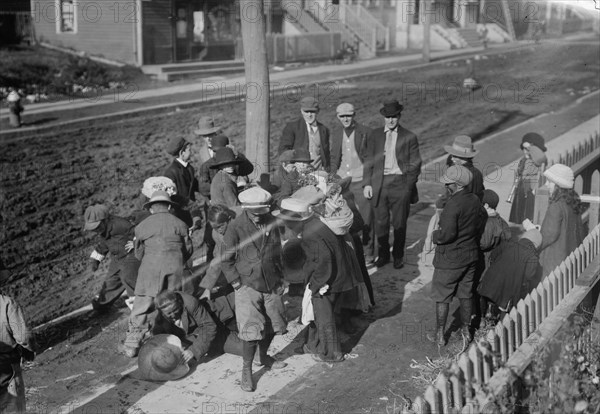 Thanksgiving Maskers scramble for pennies, between c1910 and c1915. Creator: Bain News Service.