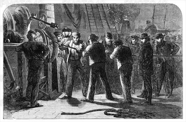 Examining the Atlantic Telegraph Cable, after raising it, on board the Great Eastern, 1865. Creator: Unknown.