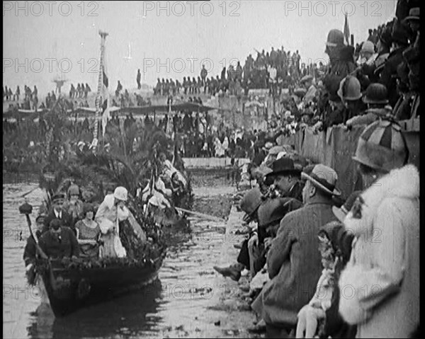 Civilians on the Margin of a River Throwing Flowers to Civilians on a Boat Heavily Decorated...1920 Creator: British Pathe Ltd.