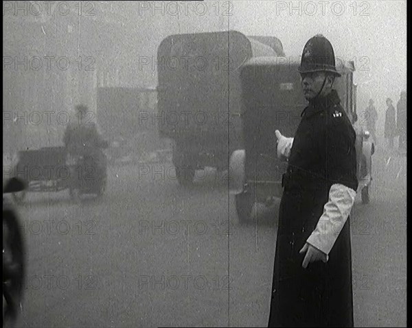 Male British Police Officer Controlling the Traffic On the Streets of London, 1920s. Creator: British Pathe Ltd.