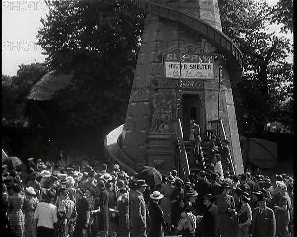 A Helter Skelter Fairground Ride in a Park With a Man at the Entrance With a Megaphone..., 1939. Creator: British Pathe Ltd.
