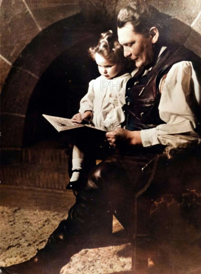 Hermann Göring, German Nazi politician and military leader, with his daughter Edda, c1939-c1942. A decorated World War I fighter ace who flew with Baron Manfred von Richthofen's squadron, Göring (1893-1946) joined the Nazi party in 1922. The following year he was involved in the Munich Beer Hall Putsch alongside Adolf Hitler. After the Nazis came to power in 1933, Göring became one of the new regime's leading figures. He commanded the Gestapo until 1934, when he handed its command over to Heinrich Himmler, and from 1935 onwards was commander of the Luftwaffe, the German air force. Captured by the Allies at the end of the Second World War, Göring was convicted of war crimes and crimes against humanity at the Nuremberg Trials, but committed suicide the night before he was due to be executed. Edda Göring was born in 1938. (Colorised black and white print).