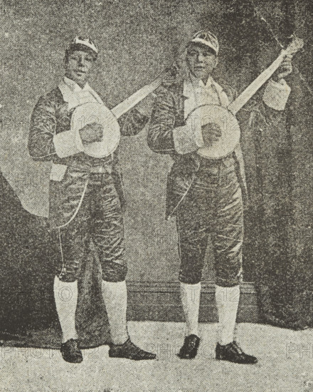 The Bohee Brothers, late 19th century. Photograph of James and George Bohee from a poster advertising their performance at International Hall, Piccadilly Circus, London. The Bohees were Black banjo players born in Canada who lived in the USA and Britain. They set up 'The Bohee Operatic Minstrels', a company of 30 musicians, singers and dancers, and toured Britain in the 1880s. The brothers imported new, improved banjos from the USA, fuelling the increasing popularity of the banjo in the UK. This interest was widespread in the 19th century but was especially popular with upper-class society. The brothers even opened a banjo academy in London's West End, where they are said to have taught the Prince of Wales, who later became King Edward VII.
