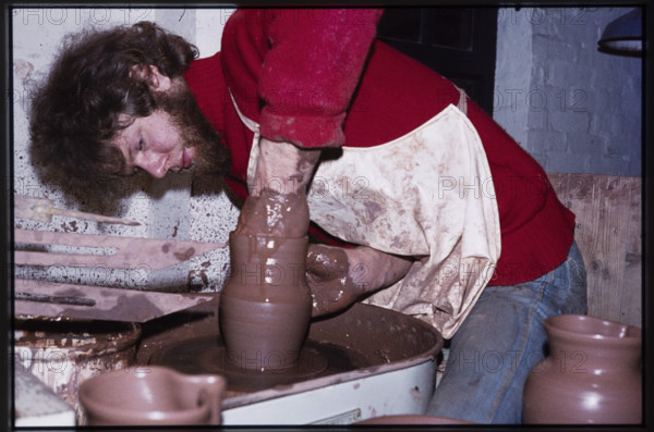 A potter working at a wheel in the Gladstone Pottery Museum, Longton, Stoke-on-Trent, 1975.