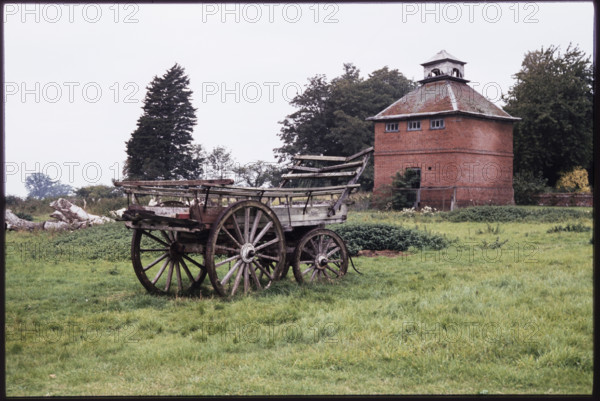 The dovecote to the south-west of Kentwell Hall seen with an old wooden wagon in the foreground, Long Melford, Babergh, Suffolk, 1980.