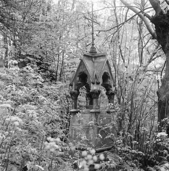 Highgate Cemetery, Swains Lane, Highgate, Camden, London, 1978-80. A square based tomb with squat columns, supporting a gothic canopy with gables surmounted by a wrought iron cross, in the West Cemetery,