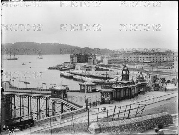 A view looking south-west from Plymouth Hoe towards Eastern King Point, showing the pavilion of Plymouth Pier, West Hoe Pier and the terraced houses along Great Western Road, 1887.