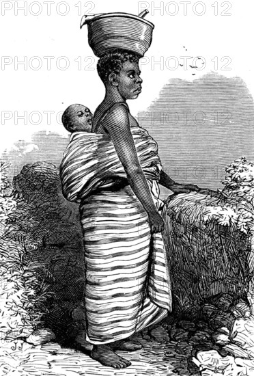 The War on the Gold Coast: a bush woman, 1873. Mother carrying her child in a baby wrap, balancing a pot on her head. Engraving 'copied from photographs lent us by Mr. James Irvine, F.R.G.S., of Birkenhead. He got them in 1869, at Cape Coast Castle, from the photographer there, who is a native of Sierre Leone'. From "Illustrated London News", 1873.