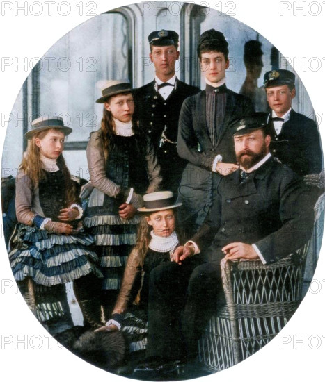 The Prince and Princess of Wales with their family on board the royal yacht, 19th century (1910). The future King Edward VII and Queen Alexandra with their children Prince Albert Victor, Duke of Clarence, Prince George and Princesses Louise, Victoria and Maud. A photograph from "The Sphere", 14th May 1910. (Colorised black and white print).