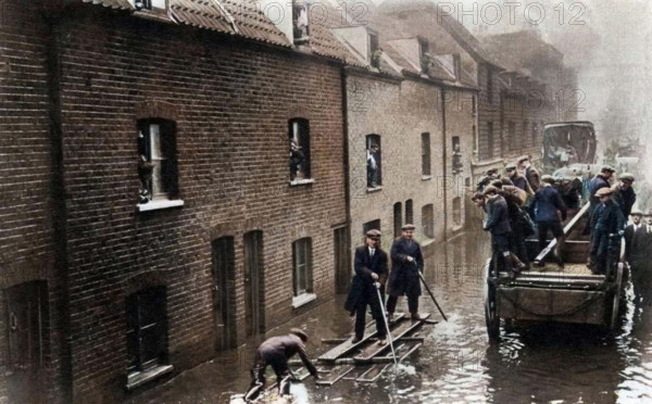 Flooding of London, January 1928 (1937). 14 people were killed when the Thames flooded in London on 6th-7th January 1928. A print from "The Story of Seventy Momentous Years, the Life and Times of King George V, 1865-1936", editor Harold Wheeler, Odhams Press Ltd, London, 1937. (Colorised black and white print).