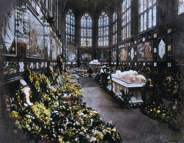 'The Albert Memorial Chapel Windsor, on the Occasion of the Funeral of H.R.H. The Duke of Clarence, January 1892', (c1897). 'The Duke's coffin stands between the tomb of the Prince Consort at the further end and that of the Duke of Albany (who died in 1884) at this end of the Chapel'. Prince Albert Victor Victor, Duke of Clarence and Avondale (1864-1892), died of pneumonia before he was thirty. The eldest son of Albert Edward, Prince of Wales (later King Edward VII), Prince Albert Victor Victor's life has been wrapped in secrecy and scandal. He is thought to have visited a male brothel, to have fathered an illegitimate child by a married woman, and was for a time rumoured to have been Jack the Ripper. From "Sixty Years A Queen: The Story of Her Majesty's Reign", by Sir Herbert Maxwell. [Harmsworth Bros, Limited, London, c1897]. (Colorised black and white print).
