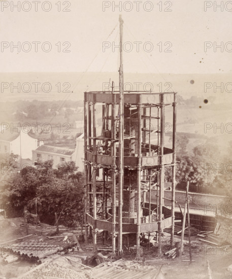 'The South Water Tower', Crystal Palace, Sydenham, 1852-1854. Designed by Sir Joseph Paxton to house the Great Exhibition of 1851 in Hyde Park, the Crystal Palace was reconstructed and enlarged in Sydenham in 1852. The first column was raised on 5 August 1852 and the palace was opened by Queen Victoria on 10 June 1854. Many exhibitions and events were subsequently held at the Crystal Palace until it burnt down on 30 November 1936. The park contained a motor racing circuit from 1937 until 1972 and the famous athletics track dates back to the foundation of the Crystal Palace Athletics Club in 1868. Plate 15 from "Photographic Views of the Progress of the Crystal Palace, Sydenham. Taken during the progress of the works, by desire of the directors, by Philip H Delamotte. Together with a list of the directors and officers of the company, etc". [London, 1855].