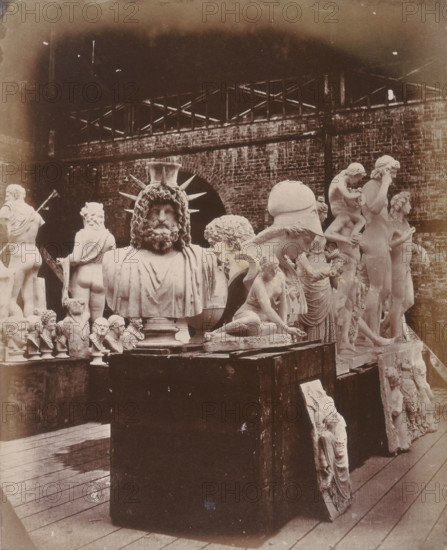'Group of Sculpture in the Roman Court', Crystal Palace, Sydenham, 1852-1854. Designed by Sir Joseph Paxton to house the Great Exhibition of 1851 in Hyde Park, the Crystal Palace was reconstructed and enlarged in Sydenham in 1852. The first column was raised on 5 August 1852 and the palace was opened by Queen Victoria on 10 June 1854. Many exhibitions and events were subsequently held at the Crystal Palace until it burnt down on 30 November 1936. The park contained a motor racing circuit from 1937 until 1972 and the famous athletics track dates back to the foundation of the Crystal Palace Athletics Club in 1868. Plate 19 from "Photographic Views of the Progress of the Crystal Palace, Sydenham. Taken during the progress of the works, by desire of the directors, by Philip H Delamotte. Together with a list of the directors and officers of the company, etc". [London, 1855].