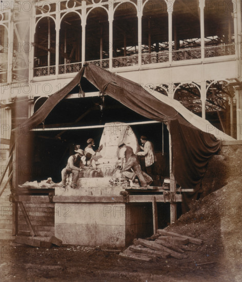 'Casting the Sphinx at the South Transept', Crystal Palace, Sydenham, 1852-1854. Designed by Sir Joseph Paxton to house the Great Exhibition of 1851 in Hyde Park, the Crystal Palace was reconstructed and enlarged in Sydenham in 1852. The first column was raised on 5 August 1852 and the palace was opened by Queen Victoria on 10 June 1854. Many exhibitions and events were subsequently held at the Crystal Palace until it burnt down on 30 November 1936. The park contained a motor racing circuit from 1937 until 1972 and the famous athletics track dates back to the foundation of the Crystal Palace Athletics Club in 1868. Plate 28 from "Photographic Views of the Progress of the Crystal Palace, Sydenham. Taken during the progress of the works, by desire of the directors, by Philip H Delamotte. Together with a list of the directors and officers of the company, etc". [London, 1855].