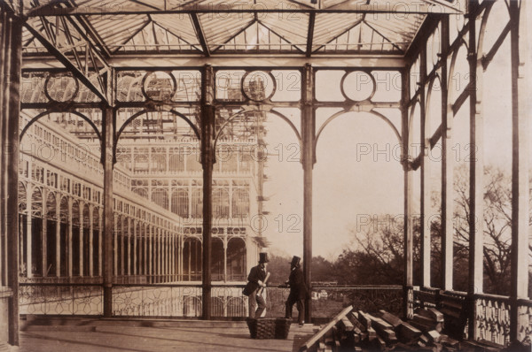 'Open Colonnade, Garden front', Crystal Palace, Sydenham, 1852-1854. Designed by Sir Joseph Paxton to house the Great Exhibition of 1851 in Hyde Park, the Crystal Palace was reconstructed and enlarged in Sydenham in 1852. The first column was raised on 5 August 1852 and the palace was opened by Queen Victoria on 10 June 1854. Many exhibitions and events were subsequently held at the Crystal Palace until it burnt down on 30 November 1936. The park contained a motor racing circuit from 1937 until 1972 and the famous athletics track dates back to the foundation of the Crystal Palace Athletics Club in 1868. Plate 34 from "Photographic Views of the Progress of the Crystal Palace, Sydenham. Taken during the progress of the works, by desire of the directors, by Philip H Delamotte. Together with a list of the directors and officers of the company, etc". [London, 1855].