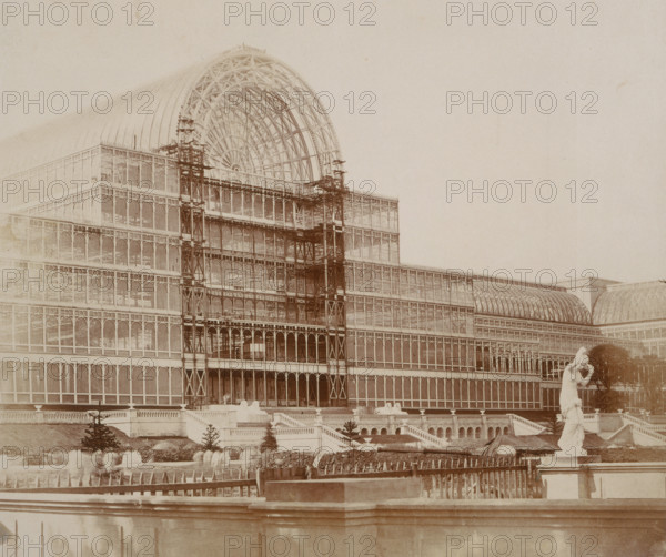 'The Centre Transept - from the Garden', Crystal Palace, Sydenham, 1852-1854.  Designed by Sir Joseph Paxton to house the Great Exhibition of 1851 in Hyde Park, the Crystal Palace was reconstructed and enlarged in Sydenham in 1852. The first column was raised on 5 August 1852 and the palace was opened by Queen Victoria on 10 June 1854. Many exhibitions and events were subsequently held at the Crystal Palace until it burnt down on 30 November 1936. The park contained a motor racing circuit from 1937 until 1972 and the famous athletics track dates back to the foundation of the Crystal Palace Athletics Club in 1868. Plate 67 from "Photographic Views of the Progress of the Crystal Palace, Sydenham. Taken during the progress of the works, by desire of the directors, by Philip H Delamotte. Together with a list of the directors and officers of the company, etc". [London, 1855].