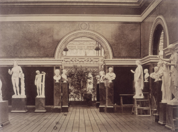 'Interior of the Roman Court', Crystal Palace, Sydenham, 1852-1854. Designed by Sir Joseph Paxton to house the Great Exhibition of 1851 in Hyde Park, the Crystal Palace was reconstructed and enlarged in Sydenham in 1852. The first column was raised on 5 August 1852 and the palace was opened by Queen Victoria on 10 June 1854. Many exhibitions and events were subsequently held at the Crystal Palace until it burnt down on 30 November 1936. The park contained a motor racing circuit from 1937 until 1972 and the famous athletics track dates back to the foundation of the Crystal Palace Athletics Club in 1868. Plate 91 from "Photographic Views of the Progress of the Crystal Palace, Sydenham. Taken during the progress of the works, by desire of the directors, by Philip H Delamotte. Together with a list of the directors and officers of the company, etc". [London, 1855].