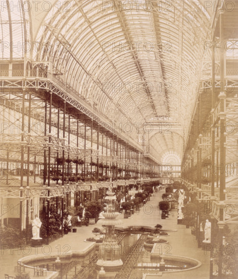 'The Nave from the South end', Crystal Palace, Sydenham, 1852-1854. Designed by Sir Joseph Paxton to house the Great Exhibition of 1851 in Hyde Park, the Crystal Palace was reconstructed and enlarged in Sydenham in 1852. The first column was raised on 5 August 1852 and the palace was opened by Queen Victoria on 10 June 1854. Many exhibitions and events were subsequently held at the Crystal Palace until it burnt down on 30 November 1936. The park contained a motor racing circuit from 1937 until 1972 and the famous athletics track dates back to the foundation of the Crystal Palace Athletics Club in 1868. Plate 98 from "Photographic Views of the Progress of the Crystal Palace, Sydenham. Taken during the progress of the works, by desire of the directors, by Philip H Delamotte. Together with a list of the directors and officers of the company, etc". [London, 1855].