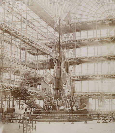'The Military Trophy erected at the visit of "Les Guides"', Crystal Palace, Sydenham, 1852-1854. Designed by Sir Joseph Paxton to house the Great Exhibition of 1851 in Hyde Park, the Crystal Palace was reconstructed and enlarged in Sydenham in 1852. The first column was raised on 5 August 1852 and the palace was opened by Queen Victoria on 10 June 1854. Many exhibitions and events were subsequently held at the Crystal Palace until it burnt down on 30 November 1936. The park contained a motor racing circuit from 1937 until 1972 and the famous athletics track dates back to the foundation of the Crystal Palace Athletics Club in 1868. Plate 100 from "Photographic Views of the Progress of the Crystal Palace, Sydenham. Taken during the progress of the works, by desire of the directors, by Philip H Delamotte. Together with a list of the directors and officers of the company, etc". [London, 1855].