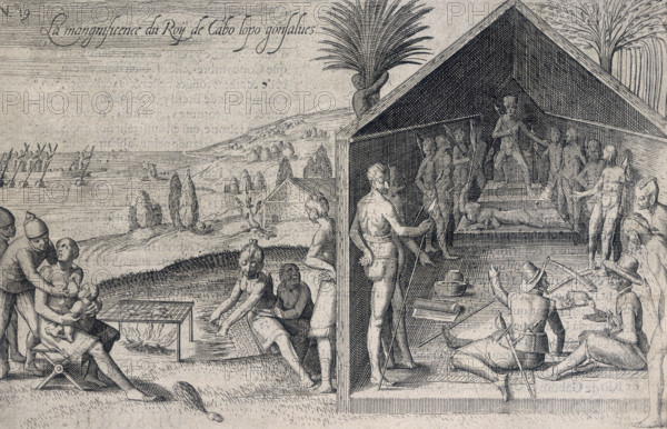 Two Europeans at an audience with a king, 1605. 'La mangnificence [sic] du Roy de Cabo Iopo gonsalves'. On the left a man grabs the breast of a woman who is suckling a child. Next to them is a sort of barbecue with food cooking on it. From "Description et Recit Historial du riche Royaume d'or de Gunea [or Guinea], aultrement nommé, la coste de l'or de Mina" (Description and Historical Account of the rich golden Kingdom of Guinea, otherwise called, the gold coast of Myna [or Mina]) by Pieter de Marees.