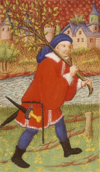 A forester having chopped down a tree, 1423. He carries the tree over his shoulder, a sharp dagger hanging from his tunic. A town can be seen the other side of the river. From the Bedford Hours, executed for the Duke of Bedford.