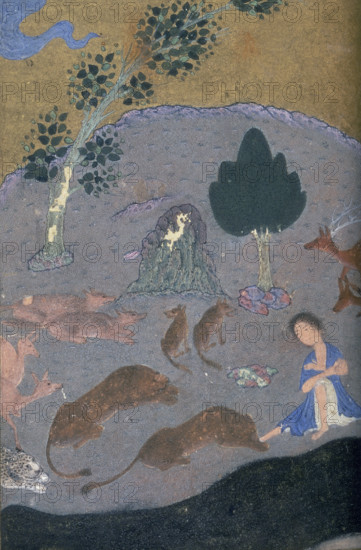 Majnun in the desert with the animals, c1410-c1411. Majnun sits in the desert surrounded by a stag, a leopard, and wolves. A scene from the love story of Majnun and Layla.