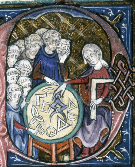 A woman teaching geometry, 1350. On the table are various geometrical shapes or instruments. The pupils crowd round the other side of the table. A boy at the front points to one of the shapes.