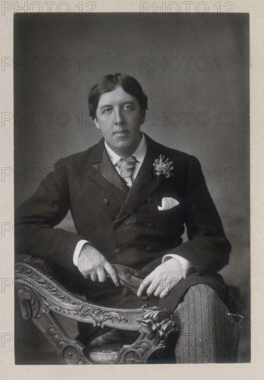 Oscar Wilde, c1890-c1894. Irish poet, author, dramatist, and exponent of "art for art's sake". His best known novel is "The Picture of Dorian Gray". He wrote a book of children's stories "The House of Pomegranates", and a series of plays including "Lady Windermere's Fan", "A Woman of No Importance", and "The Importance of Being Ernest", believed by many to be the first modern comedy in English. Wilde was convicted of sodomy over his relationship with Lord Alfred Douglas in a notorious trial, and was jailed at Reading from 1895-1897. After his release he moved to Paris and wrote "The Ballad of Reading Gaol", protesting at the inhumane conditions in prisons at the time. He died suddenly in 1900 from meningitis.