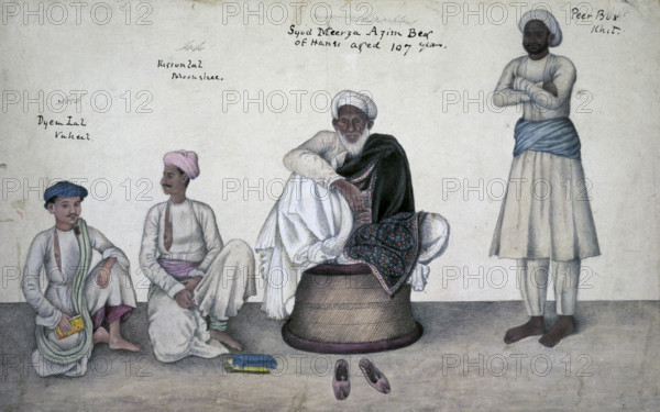 Portrait of Saiyid Mirza Azim Beg of Hansi, 1820-1830. Saiyid Mirza Azim Beg of Hansi (Syud Meerza Azim Beg of Hansi aged 107 years) seated on a cane stool with Dai Lal Vakil (Dyem Lal, Vukeel), Kisan Lal Munshi (Kissun Lal, Moonshee) and Pir Bakhsh Khitmatgar (Peer Bux, Khit). Indian centenarian dressed in white and wearing a black embroidered Kashmir shawl. Also inscribed in Persian characters. From the Skinner Album.