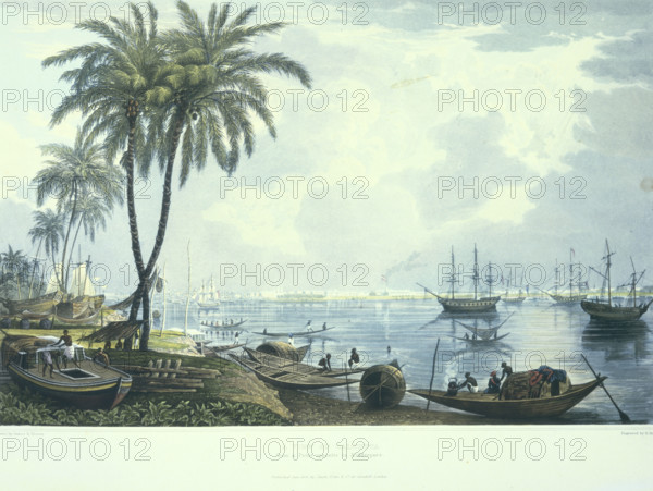 A view of Calcutta from a. Point opposite to Kidderpore, 1824-1826. Sailing ships and boats near the coast, Bay of Bengal, India. In the foreground a man is boiling a kettle on a wooden boat. From "Views of Calcutta, and its Environs".