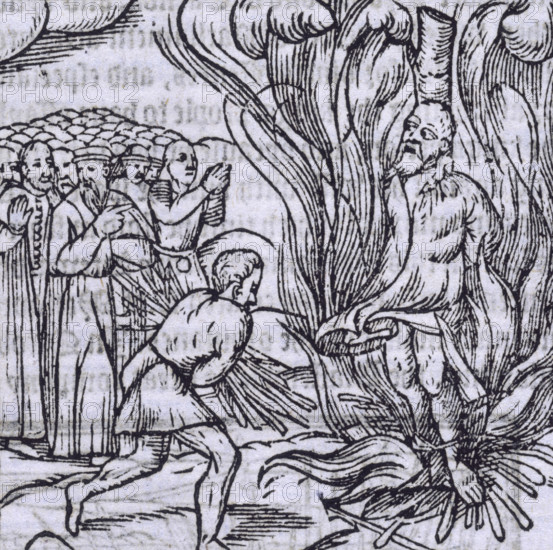The burning of George Wishart, 1546 (1577). Scottish religious reformer Wishart (1513-1546) is burned at the stake for preaching the Reformation doctrine. A man adds fuel to the fire, others watch and pray. From "...The description and chronicles of Scotland, ... till the yeare 1571" by Raphael Holinshed (London, 1577).