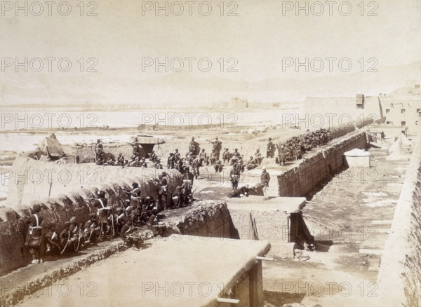 Sapper and Miners Bastion, Sherpur, Kabul, Afghanistan, c1879. Men of the Sapper and Miners unit in the compound, sitting against the wall while a number of soldiers stand guard. Sherpur was a protective compound situated to the north of the city of Kabul. The siege of the Sherpur Cantonment was a battle fought in December 1879, during the Second Anglo-Afghan War. British forces were besieged by Afghan troops, then repulsed an assault.