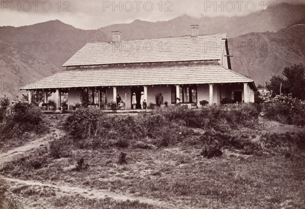 Tea estate bungalow at Sumali, 1860s. European man and children on the verandah, with Indian servants.