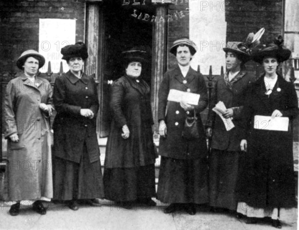 East London Deputation received by the Prime Minister, HH Asquith, June 20, 1914. From left to right: Elsie Watkins, Jessie Payne, Mrs Savoy, Mrs Bird, Julia Scurr, Mrs Parsons. Six working mothers - part of the East London Federation of Suffragettes (ELFS) - met British Prime Minister Herbert Asquith. The ELFS radically supported the vote for all men and women irrespective of class. Julia Scurr, as spokeswoman, said: 'We want to say to you that, in our view, a woman attending to her home is as much a wage earner as if she went out into a factory, and that because women bring children into the world they perform the greatest of all services to the State, and they have the greatest of all reasons to desire to help in securing its welfare'. From "The Suffragette Movement. An intimate account of persons and ideals" by E Sylvia Pankhurst. [1931].