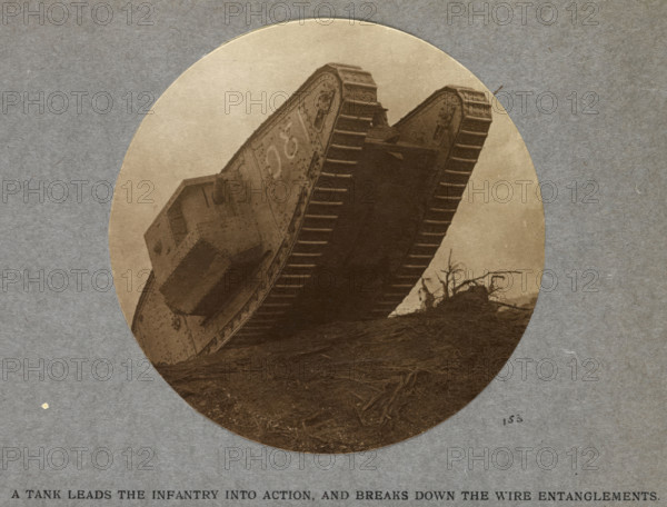 A tank leads the infantry into action and breaks down the wire entanglements. 1915 (1921). From India Office Official Record Of The Great War, 1921.