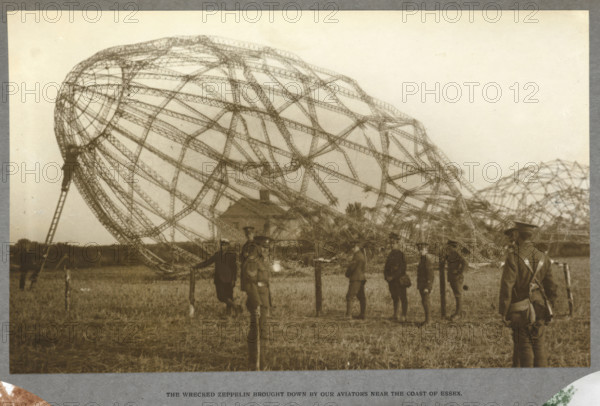 The wrecked Zeppelin brought down by our aviators near the coast of Essex, 1915 (1921). The skeleton of an airship which crashed in a field. From India Office Official Record Of The Great War, 1921.