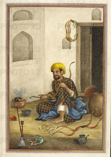 Kamdangar, a bowmaker - Shown bending the wood of a bow over a bowl of embers, (Occupational sub-division of ‘Tarkhan’ caste, bowmakers), 1825. From Tashrih Al Aqvam An Account Of Origins And Occupations Of Some Of The Sects Castes And Tribes Of India.